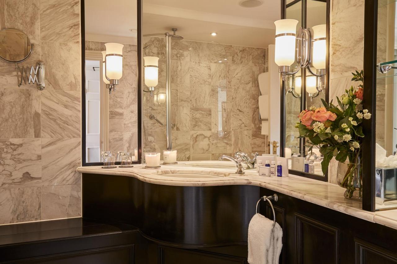Macdonald Bath Spa Hotel Εξωτερικό φωτογραφία The photo shows a luxurious bathroom featuring elegant design elements. There is a curved marble countertop with a sink, complemented by stylish silver fixtures. The walls are adorned with light-colored marble, creating a sophisticated ambiance. Seve