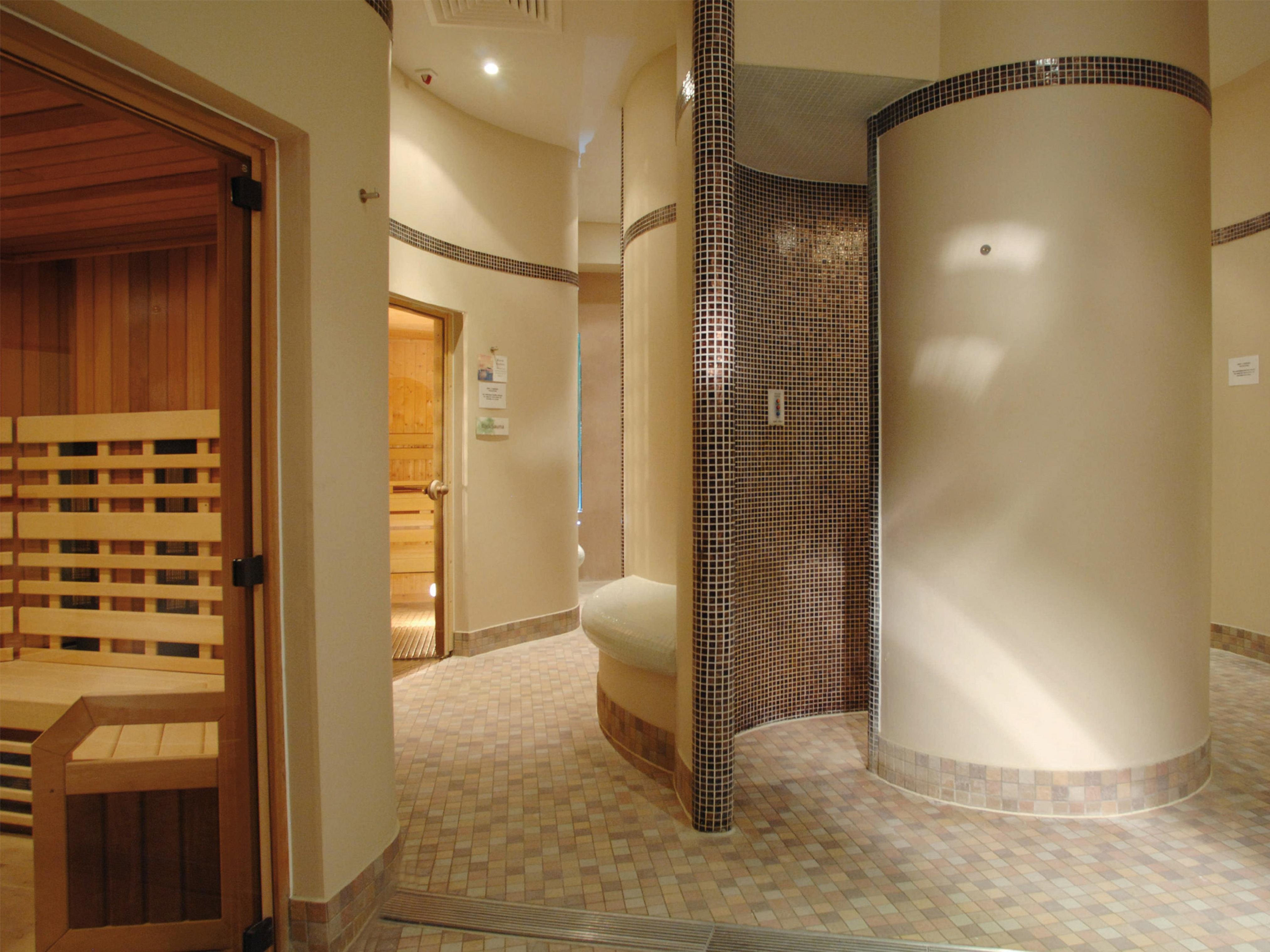 Macdonald Bath Spa Hotel Εξωτερικό φωτογραφία The photo shows a contemporary spa area featuring a sauna and relaxation space. The interior has smooth, rounded walls and tiled surfaces, creating a calming atmosphere. On one side, there's a wooden sauna with slatted seating. Nearby, a curved wall 