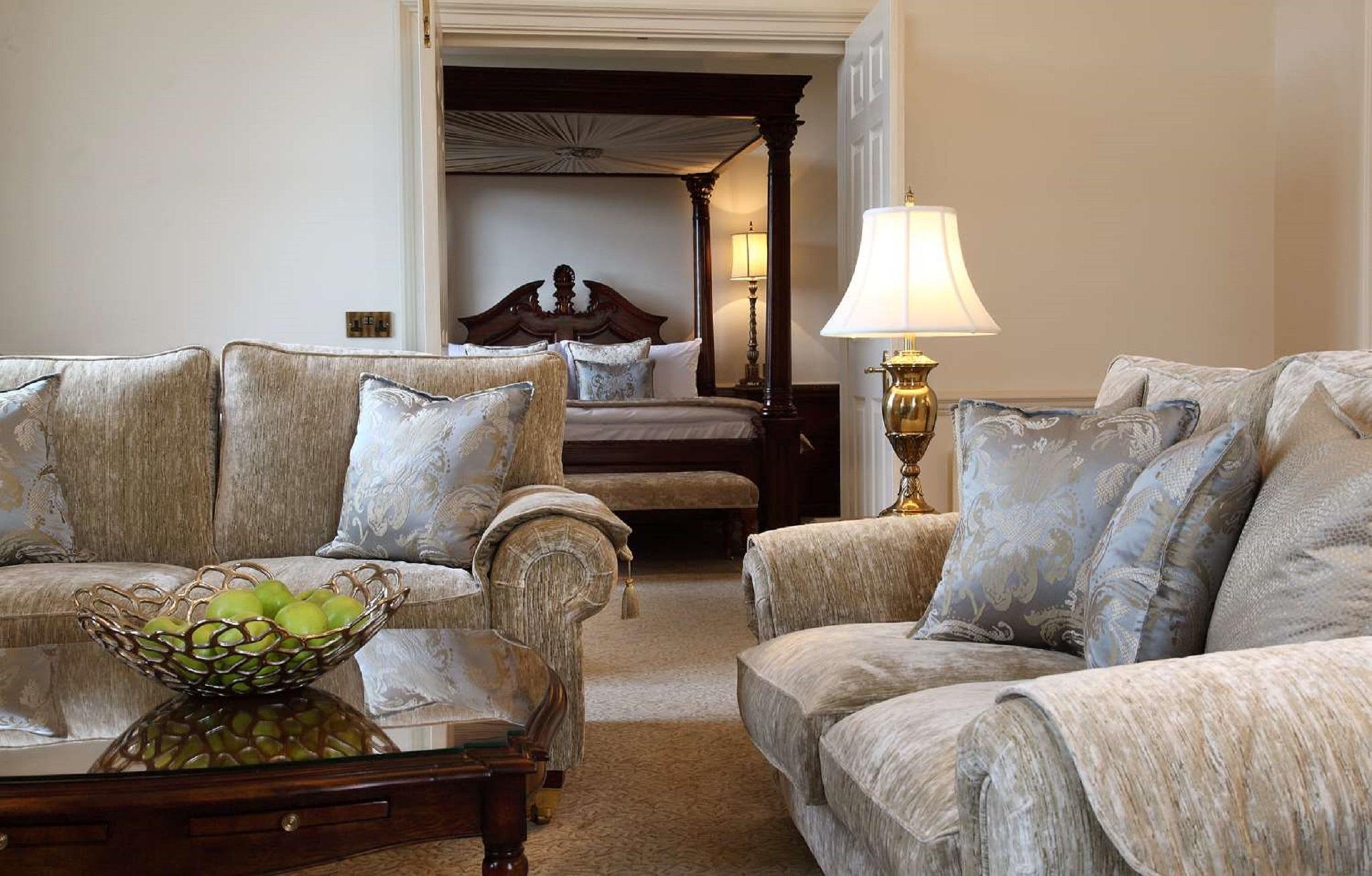 Macdonald Bath Spa Hotel Εξωτερικό φωτογραφία The photo shows a cozy living space with elegant furnishings. On the left, there is a sofa with plush cushions and a stylish armchair, both in a soft, light-colored fabric. In the center, there is a decorative glass table with a bowl containing what 