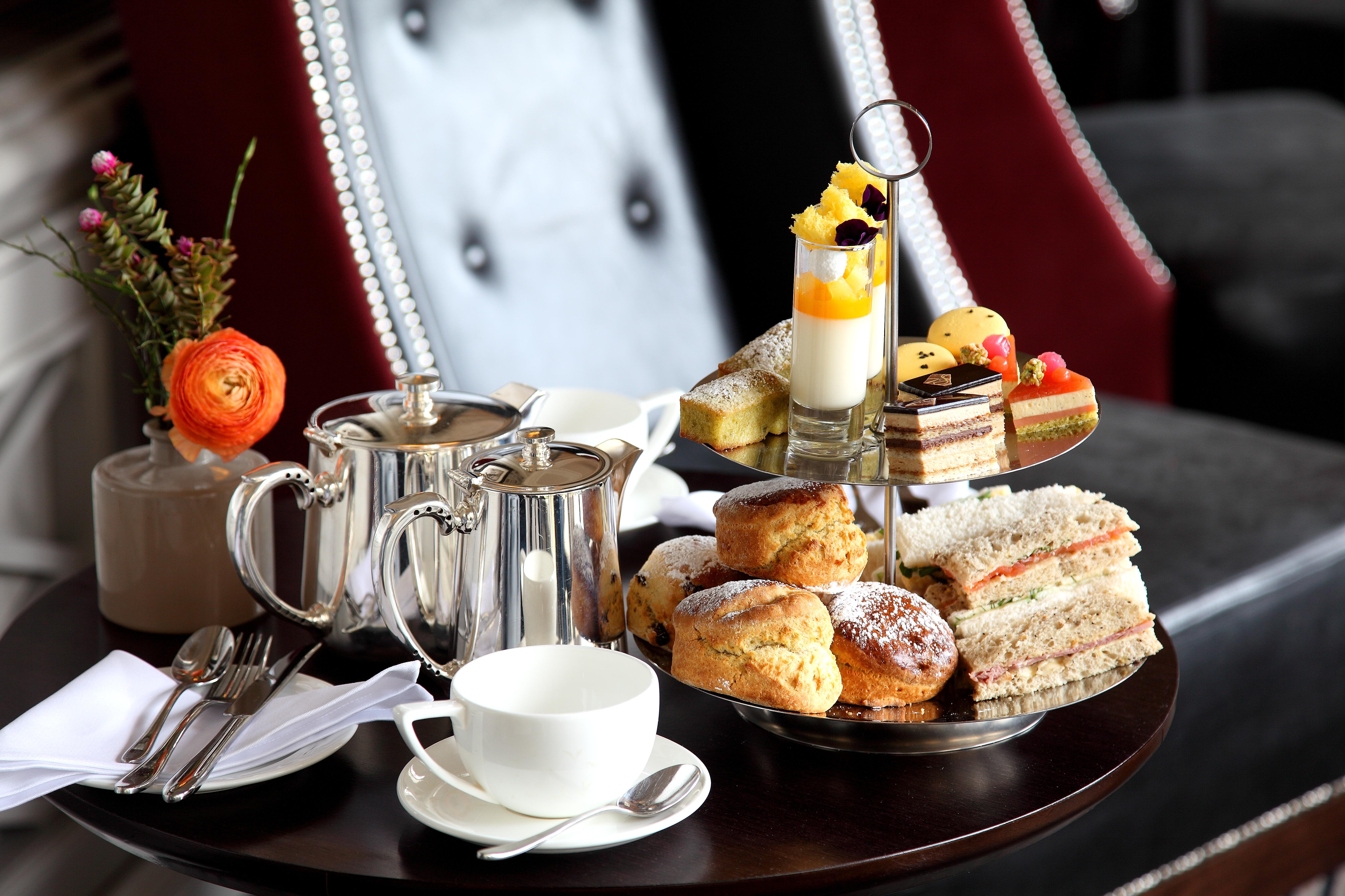 Macdonald Bath Spa Hotel Εξωτερικό φωτογραφία The photo depicts an elegantly arranged afternoon tea setting. There is a tiered stand filled with a variety of treats, including scones, sandwiches, and small desserts like cakes and pastries. Accompanying this is a teapot and a cup on the table, su